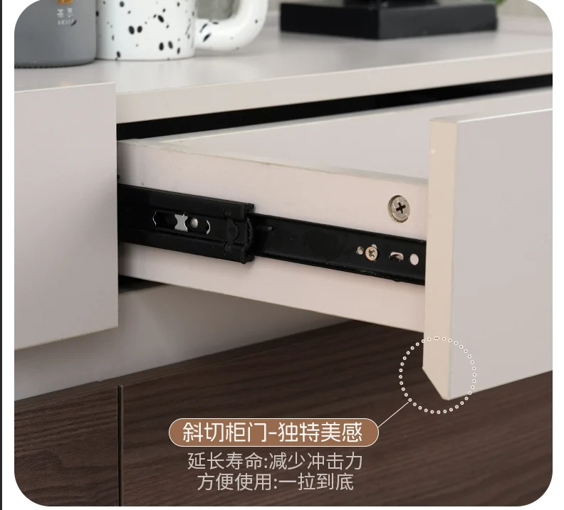 Drawer runner and chamfered handle-free sideboard drawer front